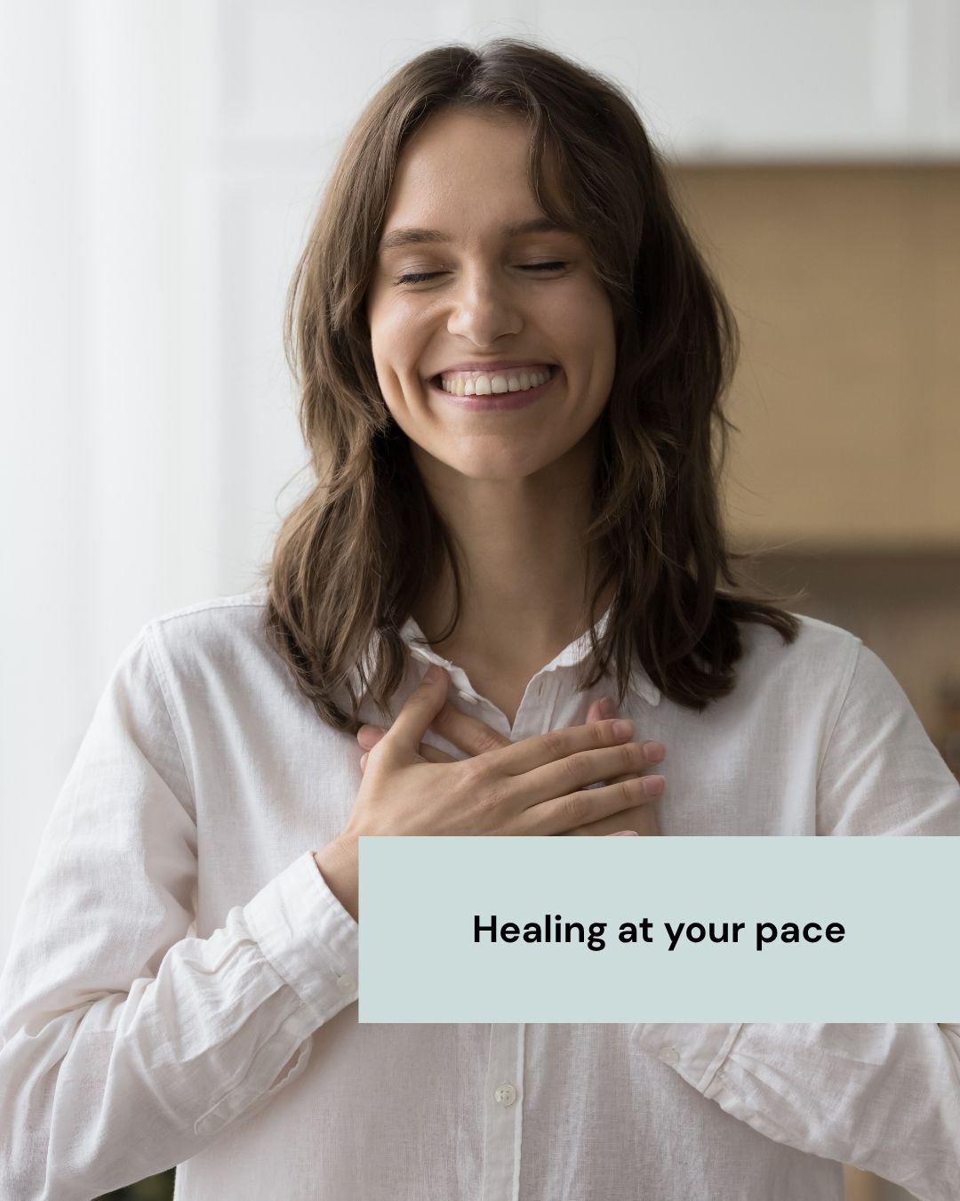 Calm woman smiling with hands on her chest